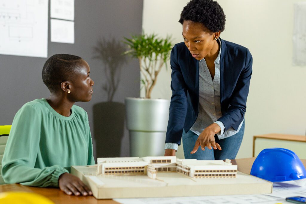 Architects discussing a building model in a design studio
